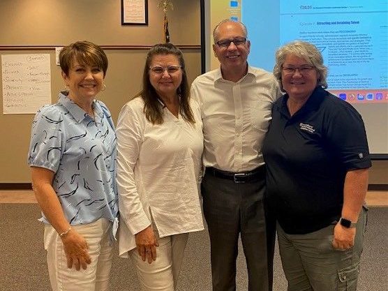 MLDS Consultants Pictured with Mike Rutherford.