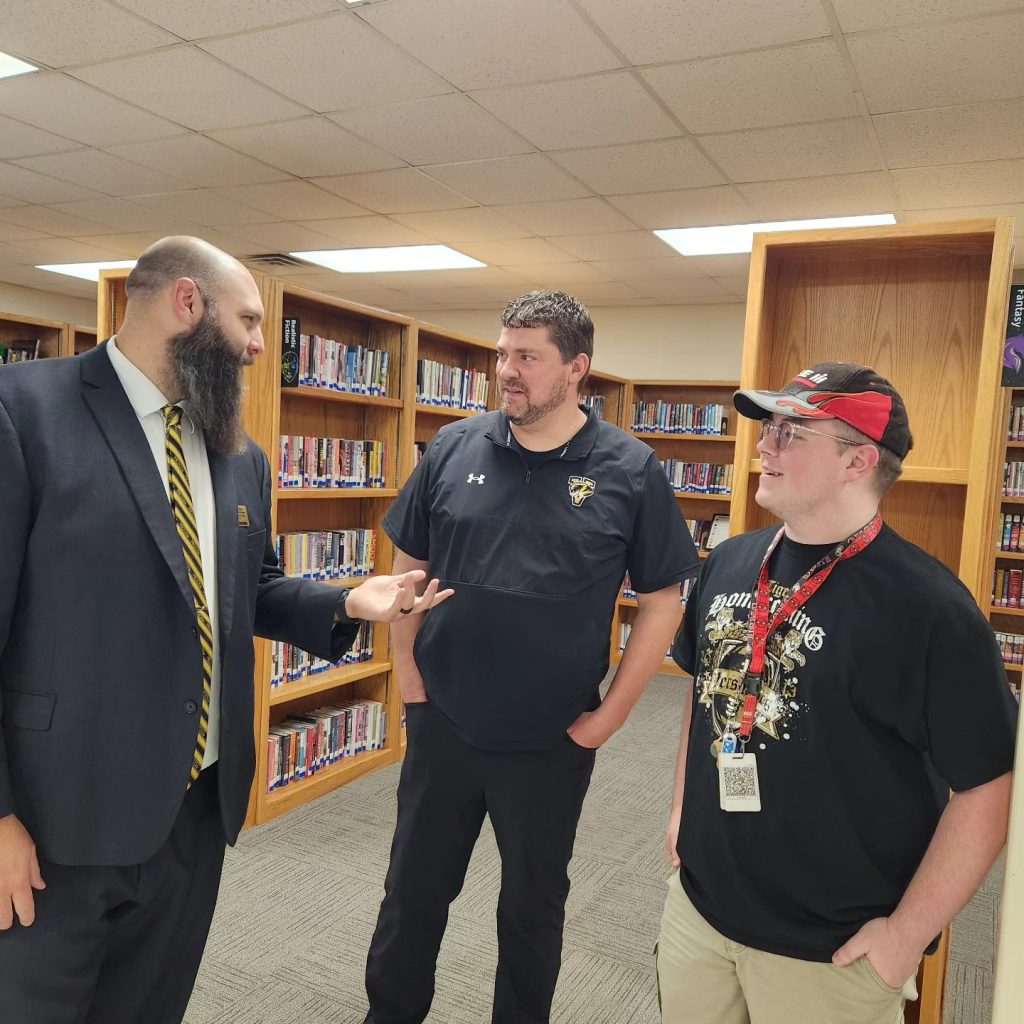 Consultant Mark Clements talking with two participants.